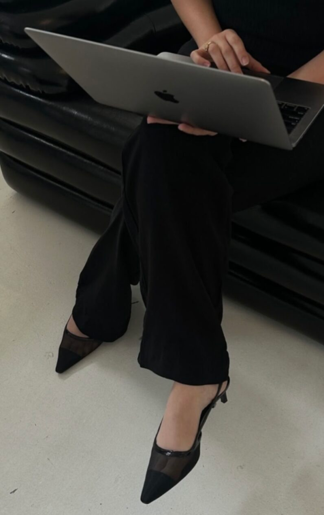 Our Blog Woman working on laptop exploring advertising strategies and digital marketing metrics.