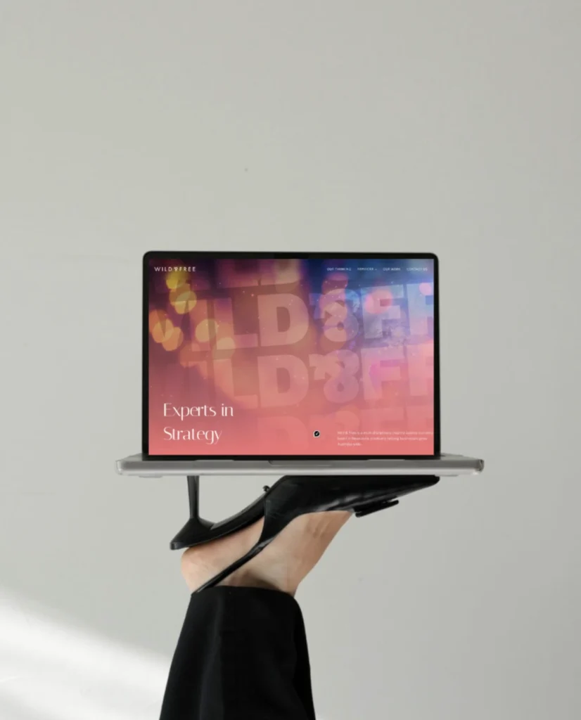 Our Blog Creative digital design process showing bold branding visuals and website mockups on screen.