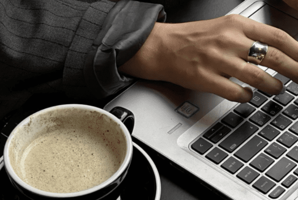 Logo design process on laptop showing a refreshed and simplified brand logo update (logos).