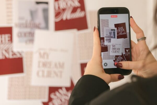 Woman photographing posters on a wall representing social media management in Newcastle.